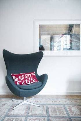 RECORD DATE NOT STATED Danish designer Arne Jacobsen EGG Easy Chair on a rug with picture hanging on wall 181039
