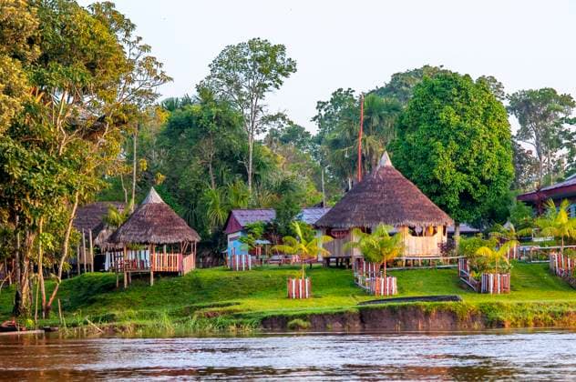 Wooden houses in the indiana village near Iquitos, Loreto, Peru, South America. The department of Loreto, the largest in Peru, was inhabited since ancient times by nomadic and semi-nomadic tribes. The evangelization of the Jungle by the Jesuits and Franciscans, in the 18th century, gave rise to the towns of Borja, Yerberos and La Laguna. In 1740, the Jesuit JosÃ Bahamonde founded the hamlets Santa Barbara de Nanay and Santa Maria de Iquitos, on the Mazan River. All the populations joined together and migrated to the high banks between the Amazon, Nanay and Itaya rivers. According to tradition, Iquitos was founded in 1757 by the Jesuits with the name of San Pablo de los Napeanos, being the first river port on the Amazon River. Belen Pe Copyright: xSergixReboredox xVWPicsx SRE-BJ0902
