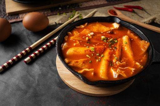 A horizontal shot of a soup in black bowl and some eggs and wooden chopsticks 380053 RECORD DATE NOT STATED