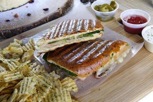 A high angle closeup shot of panini sandwich with ham, spinach, and chips on a wooden table 405533 RECORD DATE NOT STATED