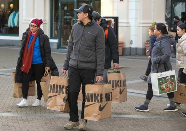 (231226) -- RICHMOND (CANADA), Dec. 26, 2023 -- People carry shopping bags on Boxing Day in Richmond, British Columbia, Canada, on Dec. 26, 2023. Boxing Day is one of the biggest shopping days in Canada. (Photo by Xinhua) CANADA-RICHMOND-BOXING DAY-SHOPPING LiangxSen 
