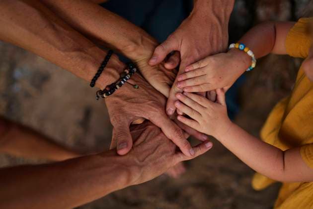 Family stacking hands together in park model released, Symbolfoto, ANNF00742