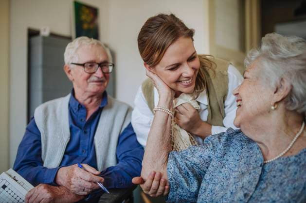 Cheerful senior woman embracing healthcare worker at home model released, Symbolfoto property released, HAPF03273