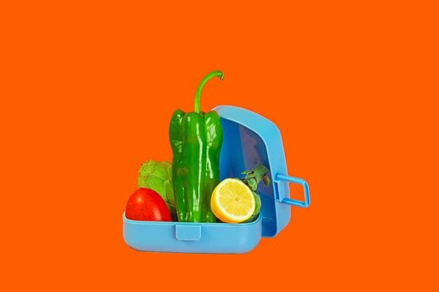 IMAGO Creative, Food, Trend, Meal Prep An open lunchbox filled with vibrant green bell peppers, lettuce, tomato, and a slice of lemon set against a contrasting orange backdrop. Model Released Rodobot_ID17553_531793_002 Copyright: xRodobotx RECORD DATE NOT STATED