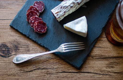 A closeup shot of brie cheese and smoked sausage on a board 736436 RECORD DATE NOT STATED