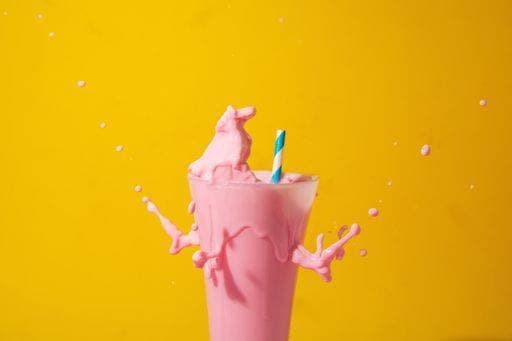 A glass of strawberry smoothie isolated on yellow and pink background 1043356 RECORD DATE NOT STATED