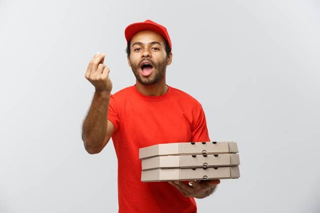Delivery Concept - Portrait of Happy African American delivery man showing delicious gesture by hand with holding boxes of pizza package. Isolated on Grey studio Background. Copy Space. Delivery Concept - Portrait of Happy African American delivery man showing delicious gesture by hand with holding boxes of pizza package. Isolated on Grey studio Background. Copy Space ,model released, Symbolfoto Copyright: xZoonar.com PhongthornxHiranlikhitx 13367910 ,model released, Symbolfoto ,property released