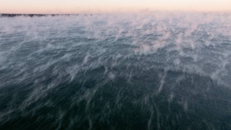 03.01.2024, Tallinn. Sea smoke, frost smoke or steam fog. It forms when a light wind of very cold air mixes with a shallow layer of saturated warm air immediately above the warmer water. The warmer air is cooled beyond the dew point and can no longer hold as much water vapor, so the excess condenses out. Photo: Sander Ilvest, Postimees Tallinn Harjumaa Estonia 1SI03JAN24A-3  Copyright: xSanderxIlvestx Sea smoke