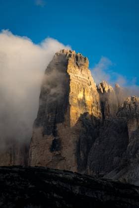 Creative Highlights World Tre Cime illuminated by sunlight and surrounded by clouds Schluderbach, Trentino-South Tyrol, Italy CR_ULGR240103G-1316088-01