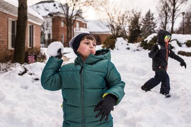 Boys in snow gear get ready to throw snowballs in yard Reading, Pennsylvania, United States CR_LIDE240105-1314633-01 ,model released, Symbolfoto