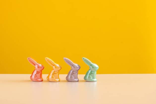 Easter concept backdrop. Cheerful Ceramic Bunnies on Yellow. London, England, United Kingdom CR_UUAB240105A4-1299139-01