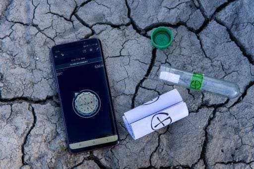 A container and GPS provider for geocaching on drought surface 2049649