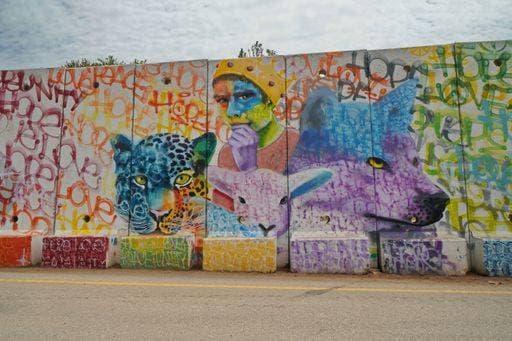 Israel and Lebanon border separation wall with graffiti near the settlement of Shtula on the Israeli side . 2086053