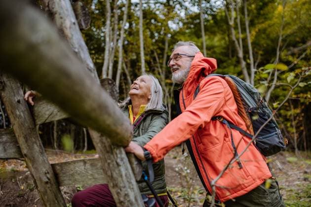 Happy senior couple climbing at hunting high seat in autumn forest. Happy senior couple climbing at hunting high seat in forest. model released Copyright: xx HHH AUTUMN SENIOR NATURE WALK 2022 HHH 159