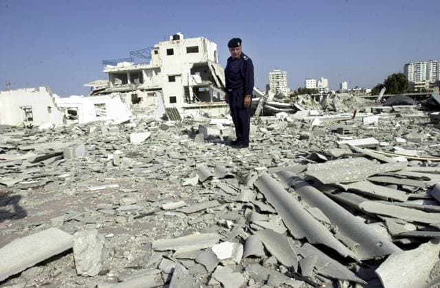 Gaza City May 12, 2002 - Palestinian police officer Maj. Fasel Gattas, stands in the rubble of the Gaza police station that was bombed 3 times by Israeli F-16 fighter aircract last year. Tensions are high in the region amongst the local population awaiting retaliation strikes by the Israeli army for recent suicide bombing attacks. Israeli tanks have massed at the Gaza border, however have yet to enter. (John Jacobfi iPhoto.ca) GAZISR05120203 Gaza Israel EDITORIAL USE ONLY Copyright: xx GAZISR05120203 JohnxJacobfix GAZISR05120203