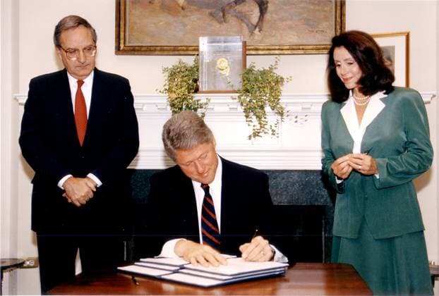 Clinton Signs MFN for China Washington, D.C. - May 28, 1993 -- United States President Bill Clinton signs a executive order renewing Most Favored Nation (MFN) trade status for China as United States Senate Majority Leader George Mitchell (Democrat of Maine) and United States Representative Nancy Pelosi (Democrat of California) look on in the Roosevelt Room of the White House on Friday, May 28, 1993. Credit: White House via CNP Washington District of Columbia United States of America EDITORIAL USE ONLY Copyright: xx P004053 -15A WhitexHousex cnpphotos006925