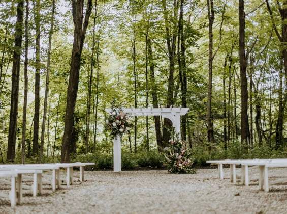arbor and wedding flowers decorating ceremony area at wedding Yarmouth, Maine, United States CR_SSNF240120C-1300167-01