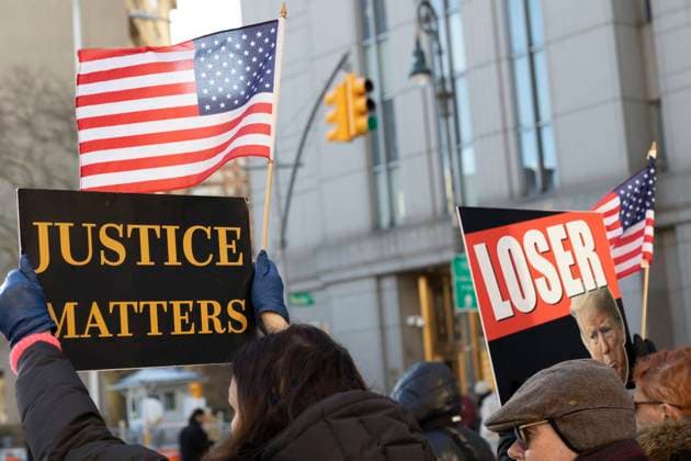 January 22, 2024, New York, New York, USA: Anti-Trump protesters with Rise & Resist hold signs outside of the U.S. District Courthouse as E. Jean Carroll and former President Donald Trump arrive for the defamation trial against Trump. .People hold American flags and signs, some with images of Trump frowning, that read Ã¢â‚¬oeLoserÃ¢â‚¬Â Justice Matters. New York USA - ZUMAr174 20240122_znp_r174_022 Copyright: xGinaxMxRandazzox