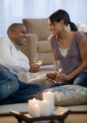 Couple drinking white wine on living room floor Jersey City, NJ, 21.12.2023, model released, TTBB_BLD072908.jpg, 25-29 years, african ethnicity, anniversary, boyfriend, candlelight, color image, domestic life, drinking, enjoying, face to face, floor, food and drink, girlfriend, happy, heterosexual couple, holding, husband, indoors, laying, leisure activity, lifestyle, livingroom, man, mixed race person, multi-ethnic group, people, photography, relaxation, romance, sitting, smiling, three quarter length, together, two people, unwinding, vertical, white wine, wife, wine, wine glass, woman, young adult, young couple, young men, young women, minority, minorities2, 20s, 20-25, 20-30, 20s, 25-30, adult, african, african american, african-america Copyright: xJGI TomxGrillx