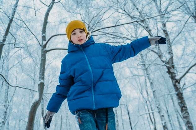 Creative Highlights Symbolbilder Boy wearing warm clothing and walking in winter forest model released, Symbolfoto, ANAF02655