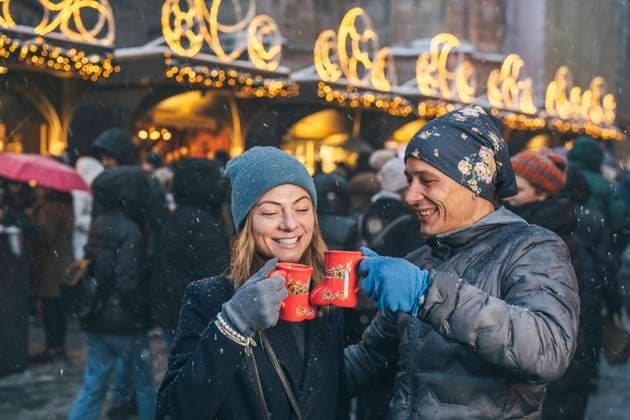 Happy man and woman toasting cups of punch drink in Christmas market model released, Symbolfoto, TILF00050
