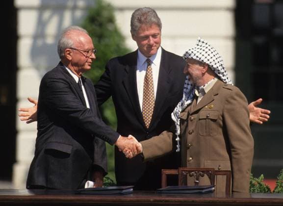 Middle East Peace Agreement Middle East Peace Agreement September 13, 1993, Yitzak Rabin, President Bill Clinton and Yasser Arafat shake hands after signing the Middle East Peace Agreement Photograph by Dennis Brack bb30 Washington DC USA EDITORIAL USE ONLY Copyright: xx x bsphotos033584