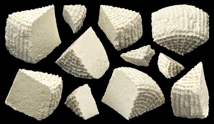 Fresh ricotta slices, homemade organic white cottage cheese on black background Fresh ricotta slices, homemade organic white cottage cheese isolated on black background, full depth of field Copyright: xZoonar.com MaksimxLashcheuskix 21044320