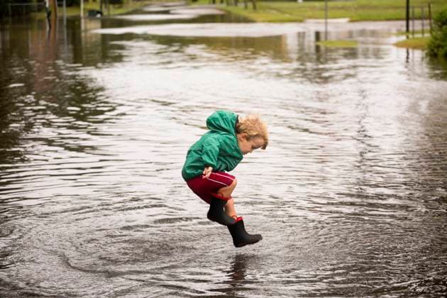 Caucasian boy jumping in puddle Norfolk, Virginia, USA, 02.10.2015, model released, TTBB_BLD188006.jpg, 2-3 years, active, alone, authentic, authenticity, blonde hair, blurred motion, boy, boys, candid, casual clothing, caucasian, childhood, color image, day, decisive moment, disaster, flooding, full length, happy, horizontal, jumping, looking down, motion, nature, norfolk, one person, outdoors, people, photography, playing, preschooler, puddle, real people, recreation, resilience, rising, rubber boot, sea level, side view, storm, united states, virginia, wellingtons, real lifeaccessory, action, adversity, america, american, americas, amusement, apparel, ascending, blond, blurry, calamity, catastrophe, cheerful, child, children, clothes, c Copyright: xRobertoxWestbrookx