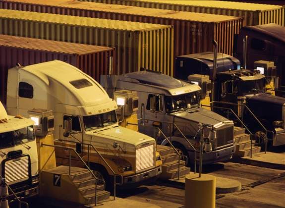 Semi-trucks parked in a row Los Angeles, CA, USA, 21.12.2023, TTBB_BLD201069.jpg, cargo container, color image, commerce, five objects, freight transportation, high angle view, horizontal, in a row, industry, night, nobody, outdoors, parked, parking lot, photography, port, port of los angeles, ready, semi-truck, stair, transportation, trucking, after dark, business, color, colour, commercialism, dark, evening, harbor, harbour, high angle, industrialization, nightfall, nighttime, nite, outdoor, outside, parking, stairway, steps, trade, transit, transport, transporting, Copyright: xTomxPaivaxPhotographyx