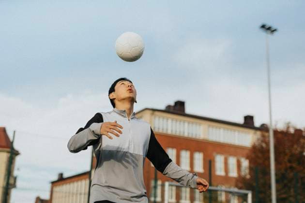 Teenage boy playing with sports ball against sky Sweden, Gothenburg, model released Copyright: xMaskotx , MA106868 MA106868