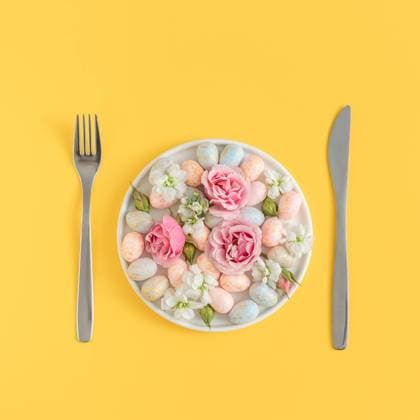 Easter dining concept with speckled eggs and flowers on a white plate Warsaw, Masovian Voivodeship, Poland CR_UUAB240130-1327380-01