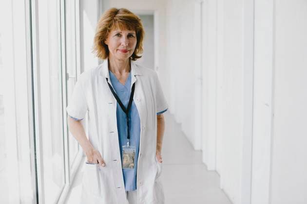 Portrait of senior female doctor standing with hands in pockets at hospital corridor Germany, Berlin, model released, property released Copyright: xMaskotx , MA106656 MA106656