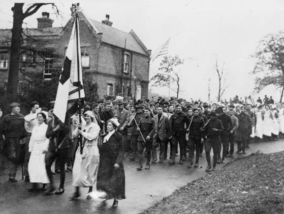 Armistice parade at the American Hospital in Dartford, 1918 (b w photo) 4072732 Armistice parade at the American Hospital in Dartford, 1918 (b w photo); Private Collection; (add.info.: The big victory parade at the American Base Hospital at Dartford, near London, on Nov. 11th, when the armistice wnet into effect. The parade was led by Miss Annie Mack of Brooklyn, the chief nurse, and Mrs. Arthur Robinson, the chief of the American women at the hospital. Mrs. Robinson, who comes from Baltimore, is carrying the Red Cross flag. The officer next to her is carrying the American flag ). Copyright: xBridgemanxImagesx 4072732