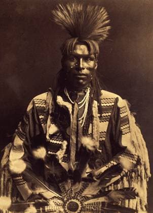 A dandy piegan. Around 1855, the young men began to make a parting in their hair from one temple to the other and to curl their back with a wand of a pre-heated rifle. Some made nates, others didn t. Photo taken from volume 6 of the encyclopedia published by Edward S. Curtis (1868-1952) on the Indians of North America, with a foreword by Theodore Roosevelt. Between 1907 and 1930, 20 volumes were published. PCT4263784 A dandy piegan. Around 1855, the young men began to make a parting in their hair from one temple to the other and to curl their back with a wand of a pre-heated rifle. Some made nates, others didn t. Photo taken from volume 6 of the encyclopedia published by Edward S. Curtis (1868-1952) on the Indians of North America, with a Copyright: xBridgemanxImagesx 4263784