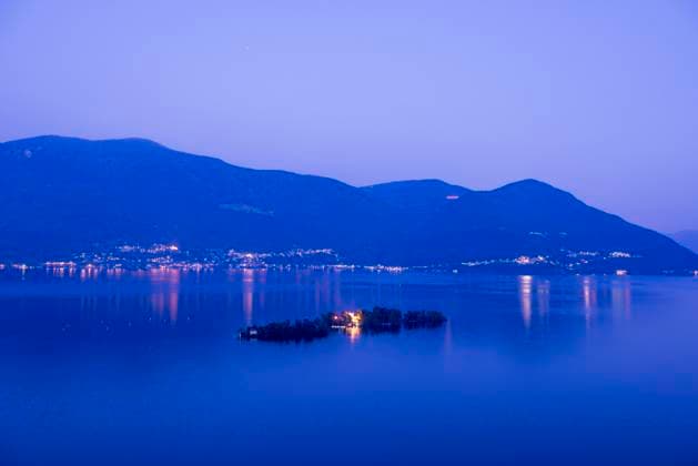 Brissago islands on alpine lake Maggiore in blue hour with mountain in Ticino, Switzerland. Brissago Islands Ticino Switzerland  Copyright: xSodatechxAG,xSwitzerlandx 4452-20461239
