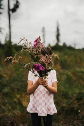 Creative Highlights Symbolbilder Young girl holding purple flowers in field Huntington Beach, California, United States CR_RASI24022072-1354246-01 ,model released, Symbolfoto
