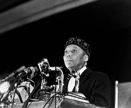 Elijah Muhammad standing behind microphones at podium, Stanley Wolfson, New York World-Telegram and the Sun Newspaper Photograph Collection, 1964 Elijah Muhammad standing behind microphones at podium, Stanley Wolfson, New York World-Telegram and the Sun Newspaper Photograph Collection, 1964. Copyright: 1010_05_ghi-circa12284