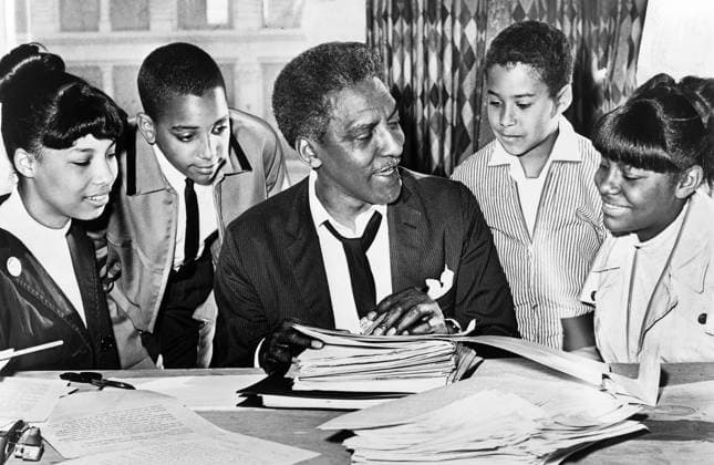 Bayard Rustin (center) speaking with (left to right) Carolyn Carter, Cecil Carter, Kurt Levister, and Kathy Ross, before demonstration, Ed Ford, New York World-Telegram and the Sun Newspaper Photograph Collection, 1964 Bayard Rustin (center) speaking with (left to right) Carolyn Carter, Cecil Carter, Kurt Levister, and Kathy Ross, before demonstration, Ed Ford, New York World-Telegram and the Sun Newspaper Photograph Collection, 1964. Copyright: 1010_05_ghi-circa12285
