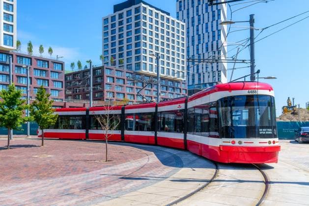 Toronto, Canada, Distillery District Loop. A modern Bombardier tramway or streetcar turns in the railroad tracks Toronto, Canada, Distillery District Loop. A modern Bombardier tramway or streetcar turns in the railroad tracks. Copyright: Â¬ RobertoxMachadoxNoa 4062_40_RMN4116
