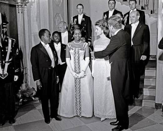 President John F. Kennedy Attends Dinner in Honor of President of the Ivory Coast, Félix Houphouët-Boigny United States President John F. Kennedy and First Lady Jacqueline Kennedy stand in front of the Grand Staircase of the White House in Washington, DC prior to a dinner in honor of President of the Ivory Coast, Félix Houphouët-Boigny, and First Lady of the Ivory Coast, Marie-Thérèse Houphouët-Boigny on May 22, 1962. Front row (L-R): President Houphouët-Boigny; Mrs. Houphouët-Boigny; Mrs. Kennedy; President Kennedy. Others (L-R): Ambassador of the Ivory Coast, Henri Konan Bédié; U.S. Ambassador to the Ivory Coast, R. Borden Reams; Military Aide to President Kennedy, General Chester V. Clifton; Air Force Aide to President Kennedy, Brigadier Copyright: xx ArniexSachsx cnpphotos066035