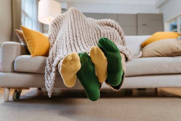 Loving couple under blanket on sofa at home model released, Symbolfoto property released, YTF01688