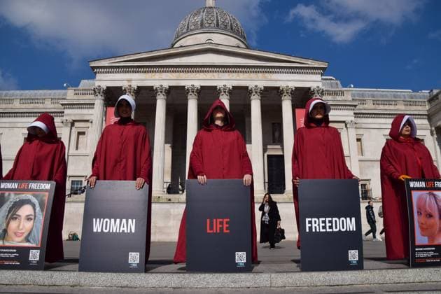 March 8, 2024, London, England, UK: Protesters in Trafalgar Square. Women wearing The Handmaid s Tale costumes marched through central London in support of freedom for Iran on International Women s Day. London UK - ZUMAv130 20240308_zip_v130_001 Copyright: xVukxValcicx