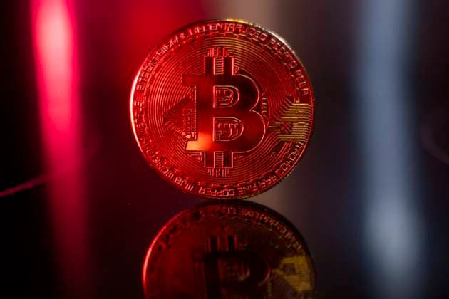 Bitcoin Bitcoins golden physical coin illustration on dark black background with reflection and vibrant color light illumination. Visual representations of the digital Cryptocurrency Bitcoin. Bitcoin with the symbol BTC, XBT is a popular digital currency that showed growth and is widely spread, accepted from banks, markets and other services and shops as ways of payments. The exchange rate today for 1 bitcoin blockchain is nearly 72.000 US Dollar setting a new record high the recent day. Bitcoin is traded in historical record all-time high prices touching almost $72.750 in the markets in March 2024. Amsterdam, the Netherlands on March 10, 2024 Amsterdam Netherlands  Copyright: xNicolasxEconomoux originalFilename: economou-notitle240310_npNsE.jpg