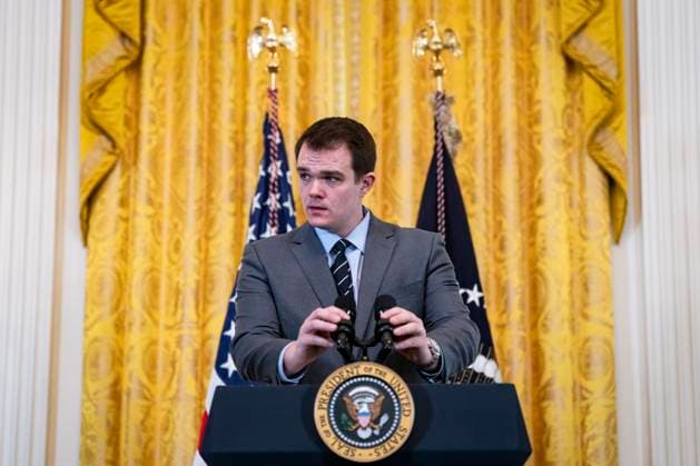 Jacob Spreyer, personal aide to US President Joe Biden, prepares the podium during a Women s History Month reception in the East Room in Washington, DC on Monday, March 18, 2024. The Biden administration is rolling out an executive order to strengthen women s health research standards across federal agencies and prioritize its funding in an effort to close the gap on long-standing disparities.  WAX20240318836 AlxDrago