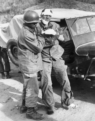 KOREA: WOUNDED SOLDIER. An American soldier of the 7th Division is led toward a jeep after being wounded in the fighting on Triangle Hill. Photograph, 17 October 1952.  Copyright: xGRANGERx xGRANGERx 0017831