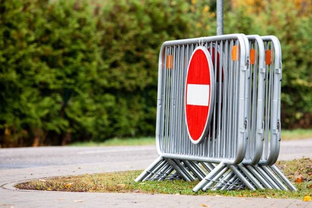 Barrier, metal fence for security for holding off people and transport on mass events, road sign for entry forbidden Copyright: xEdgarsxSermulisx