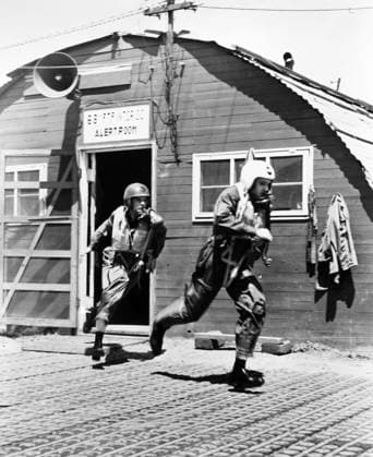 KOREAN WAR, 1953. Radar observer Captain Hugo Schott, left, and pilot Second Lieutenant Harold Riggs enroute to their plane after hearing the scramble signal. Photographed January 1953.  Copyright: xGRANGERx xGRANGERx 0034593
