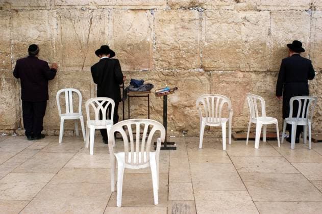 Jewish pray at the Western Wall in Jerusalem Israel JERUSALEM - OCT 08 :Jewish men pray at the Western Wall during the High Holy Days on Oct 08 2005.During the 10 days before Yom Kippur Holiday Jewish people practice Teshuvah - engaging in repentance. Jerusalem ISRAEL EDITORIAL USE ONLY Copyright: xx RafaelxBen-Ari ChameleonsxEyex cewitness086994