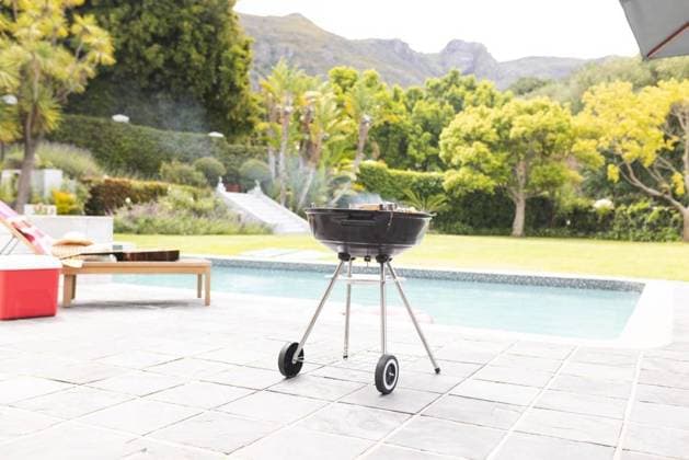 A charcoal grill is ready for a barbecue by a poolside with lush greenery in the background A charcoal grill is ready for a barbecue by a poolside with lush greenery in the background. The setting suggests a relaxing outdoor gathering or family event at a home with a scenic view., model released, , property released, Cape Town, South Africa, 15.11.2023, 4951665.jpg, charcoal grill,barbecue,poolside,lush greenery,outdoor gathering,family event,home,scenic view,relaxation,outdoor,gathering,cooking,grilling,food,summer,party,leisure,lifestyle,backyard,cooking area,outdoor cooking,barbecue grill,cookout,meal,delicious,smoke,fire,preparation,chef,meat,vegetables,charcoal,firewood,flames,cooking equipment,grill grate,summer vibes,leisure time,ba