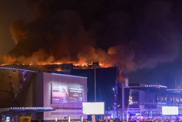 RUSSIA, MOSCOW REGION - MARCH 22, 2024: Smoke rises over the Crocus City Hall in the town of Krasnogorsk where unidentified persons opened fire. Evacuation is underway. Vladimir Gerdo TASS  68457036